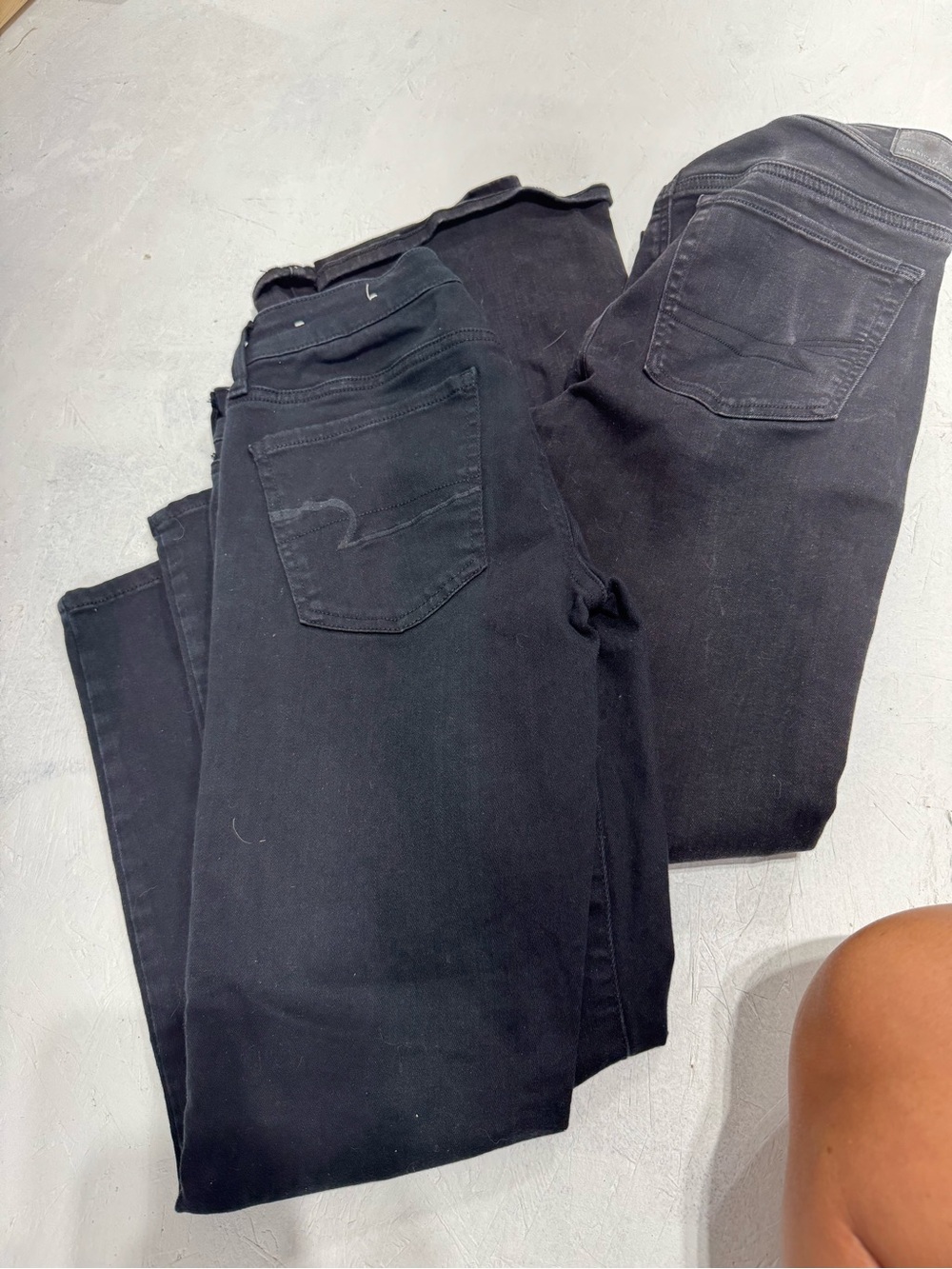 2 pair of black American Eagle jeans